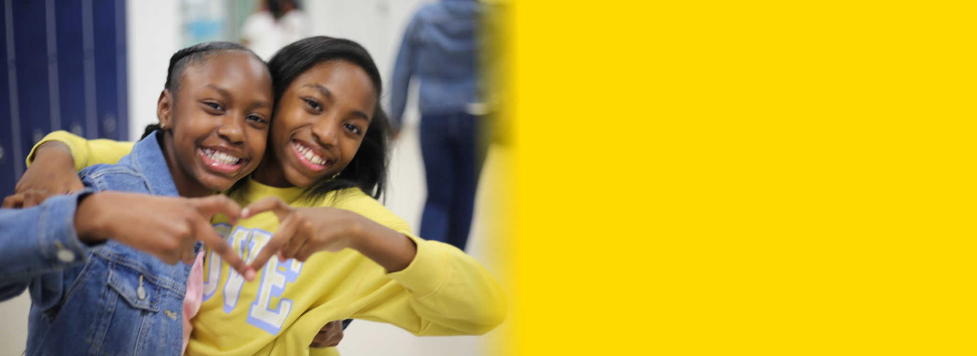 girls making heart with hands